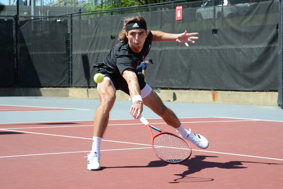 Senior Robin Catry lunges to reach the ball during the match against Virginia at the Dail Outdoor Tennis Stadium on Sunday, April 9, 2023. Catry won his singles match 2-0. The Wolfpack lost to the Cavaliers 4-2.