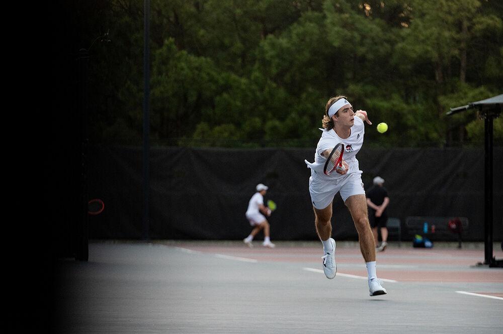 Senior Robin Catry sprints to forehand the ball during the match against Wake Forest at Dail Outdoor Tennis Stadium on Wednesday, April 12, 2023. Catry won both his singles and doubles matches. NC State beat Wake Forest 4-2.