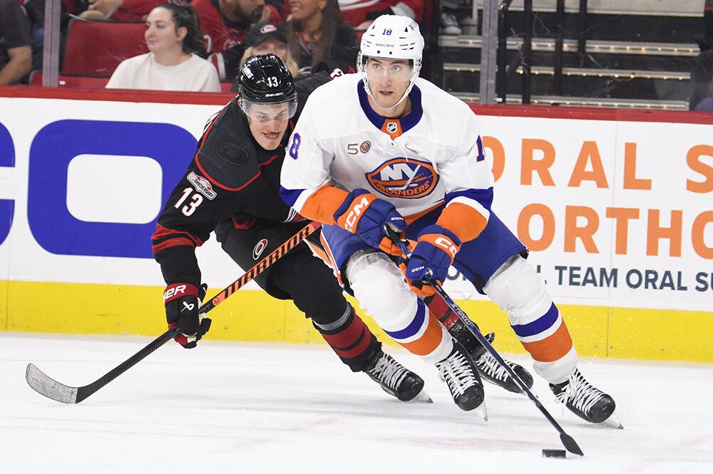 Carolina Hurricanes right wing Jesse Puljujarvi defends a New York Islanders opponent in PNC Arena on Sunday, April 2, 2023. Puljujarvi had one assist and one shot on goal throughout the game. The Hurricanes won 2-1.