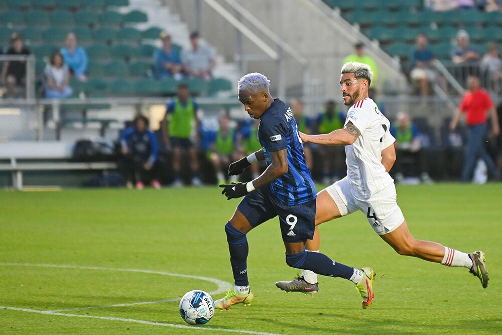 North Carolina FC forward Oalex Anderson dribbles the ball away from a Chattanooga Red Wolves opponent towards the goal at Sahlen's Stadium in WakeMed Soccer Park on Friday, April 21, 2023. NCFC beat the Red Wolves 3-0.