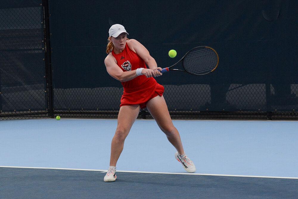 Junior Sophie Abrams backhands the ball during the match against UNC-Chapel Hill at the Cone-Kenfield Tennis Center on Thursday, April 6, 2023. The Wolfpack lost to the Tar Heels 7-0.
