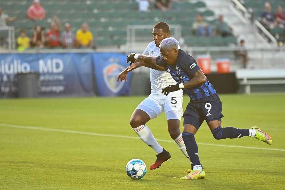 North Carolina FC forward Oalex Anderson dribbles the ball away from a Chattanooga Red Wolves opponent at Sahlen's Stadium in WakeMed Soccer Park on Friday, April 21, 2023. NCFC beat the Red Wolves 3-0.