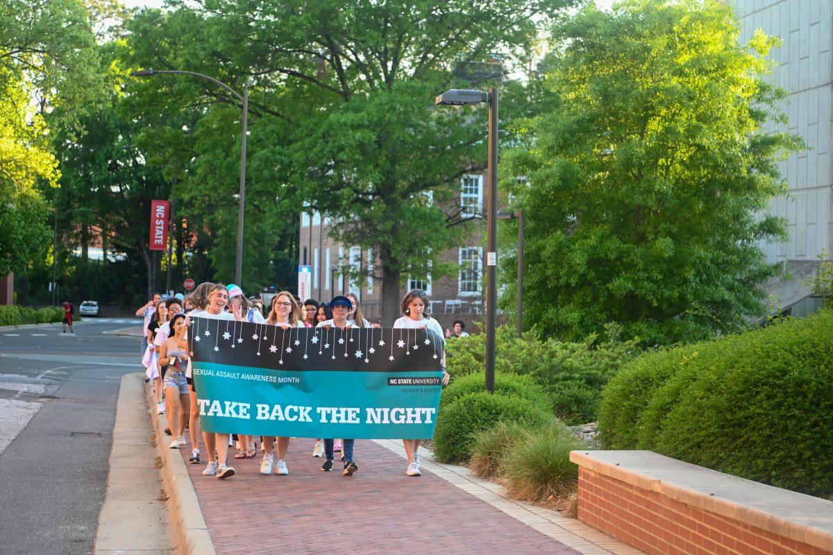 Student demonstrators march to the Brickyard from the Free Expression Tunnel for the Take Back The Night event on Thursday, April 13, 2023.