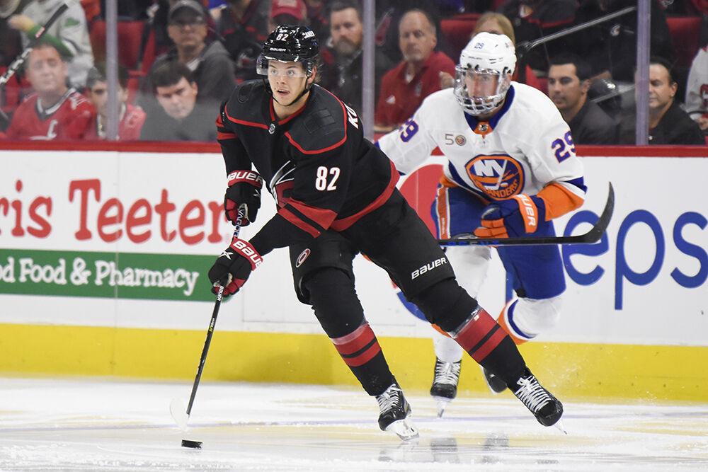 Carolina Hurricanes center Jesperi Kotkaniemi dribbles the puck up the ice during the game against the New York Islanders in PNC Arena on Sunday, April 2, 2023. Kotkaniemi had one goal and four shots on goal throughout the game. The Hurricanes won 2-1.