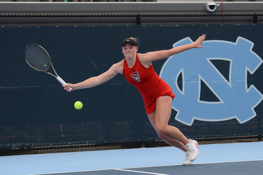 Junior Amelia Rajecki reaches for the ball during the match against UNC-Chapel Hill at the Cone-Kenfield Tennis Center on Thursday, April 6, 2023. The Wolfpack lost to the Tar Heels 7-0.