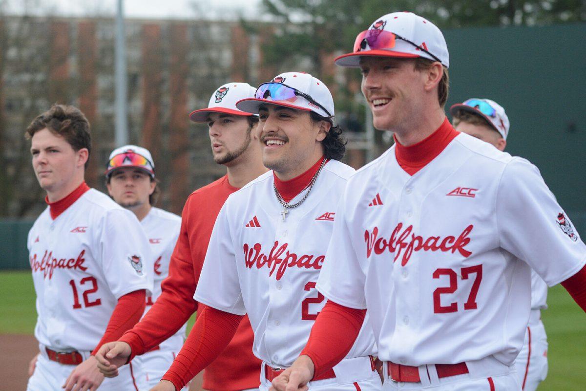 Members of the NC State baseball team smile as they walk to the dugout during the game against Wagner on Doak Field at Dail Park on Sunday, Feb. 19, 2023. The Wolfpack beat the Seahawks 9-0.