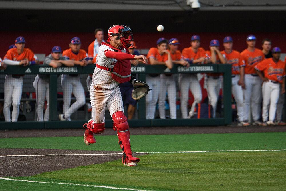 Sophomore catcher Jacob Cozart throws to beat a runner to first base during the Wolfpack's home game against the Clemson Tigers on Doak Field at Dail Park on Friday, April 21, 2023. The Tigers beat the Wolfpack 10-2.