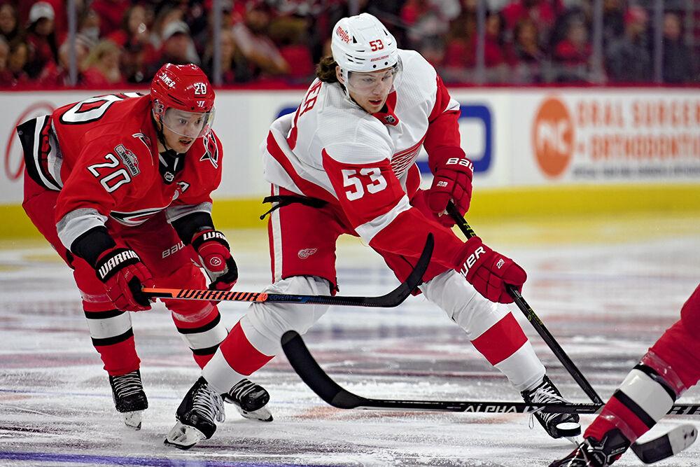 Carolina Hurricanes center Sebastian Aho defends Detroit Red Wings opponent in PNC Arena on Tuesday, April 11, 2023. The Hurricanes won 4-1.