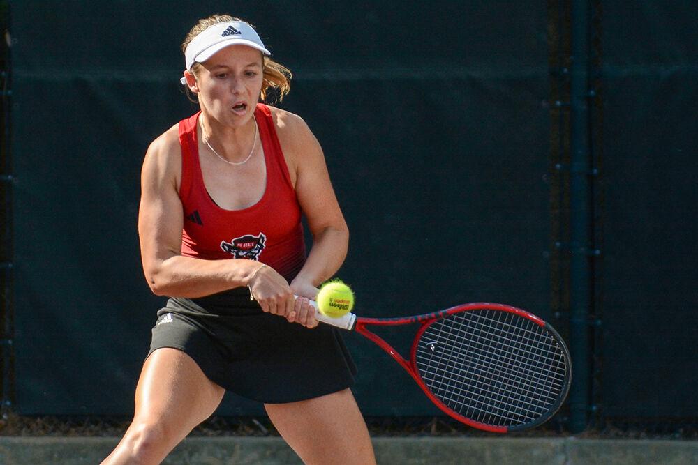 Junior Gina Dittman backhands the ball during the match against Kansas at Dail Outdoor Tennis Stadium on Saturday, May 6, 2023. The Wolfpack defeated the Jayhawks 4-0.