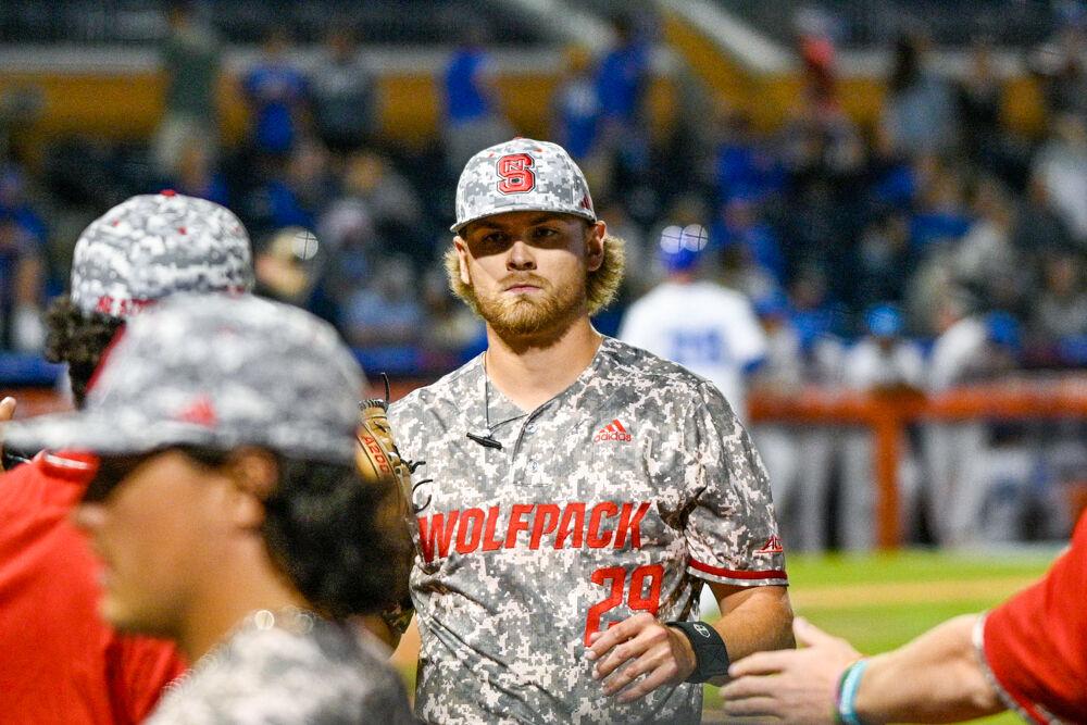Redshirt junior pitcher Logan Whitaker greets his teammates after striking out the opposing team during the ACC Tournament game against Duke at Durham Bulls Athletic Park on Tuesday, May 23, 2023. Whitaker pitched 2.0 innings allowing zero hits while striking out four batters. NC State beat Duke 8-7.