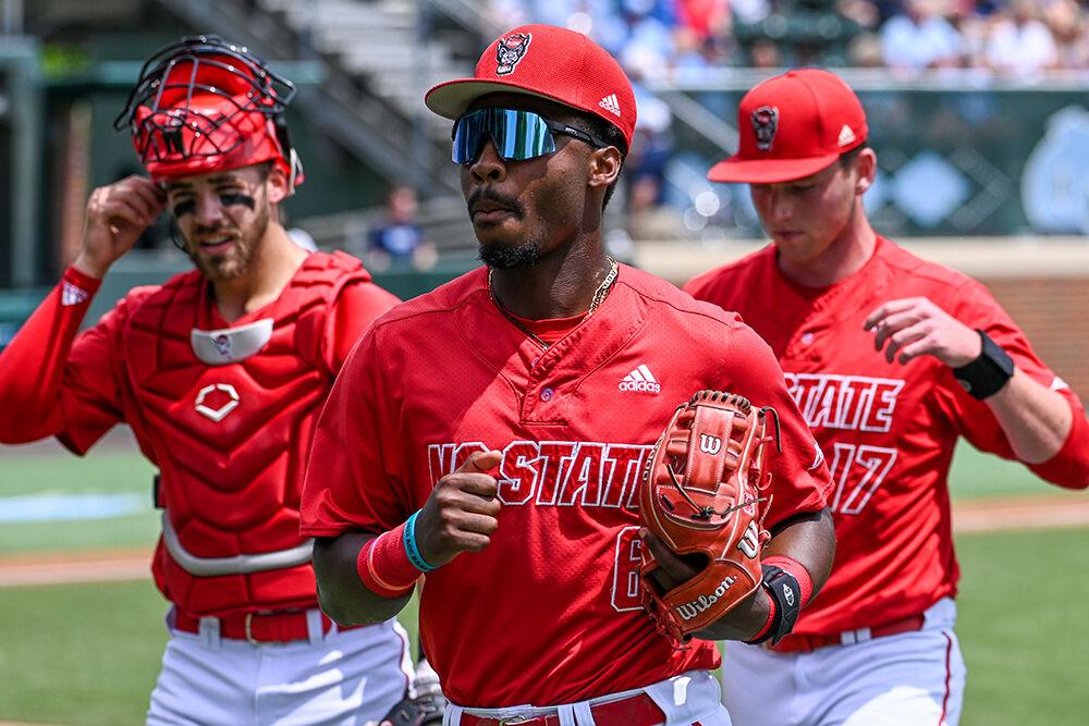 Sophomore catcher Jacob Cozart, junior infielder LuJames Groover and junior pitcher Sam Highfill run to the dugout during the game against UNC-Chapel Hill at Bryson Field at Boshamer Stadium on Saturday, May 13, 2023. NC State lost to UNC-CH 12-2.
