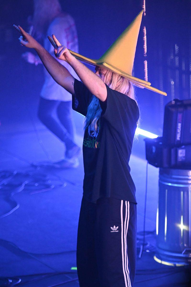 Dylan Brady, one half of 100 Gecs holds up peace signs to the crowd at The Ritz - Raleigh on Tuesday, May 2, 2023. The concert, opened by Machine Girl had some of 100 Gecs' biggest hits performed such as "money machine" and "hand crushed by a mallet."