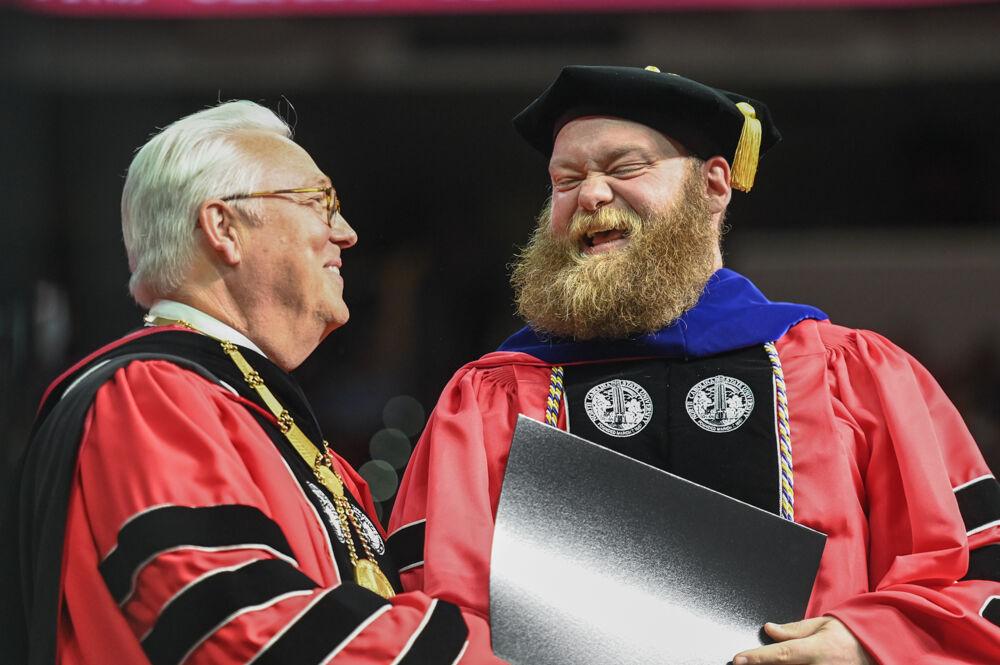 Chancellor Randy Woodson and Justin Egresitz, a doctoral student in engineering and technology education, celebrate together during&#160;the Spring Commencement Ceremony in PNC Arena on Saturday, May 6, 2023. Over 6,000 graduates were in attendance.
