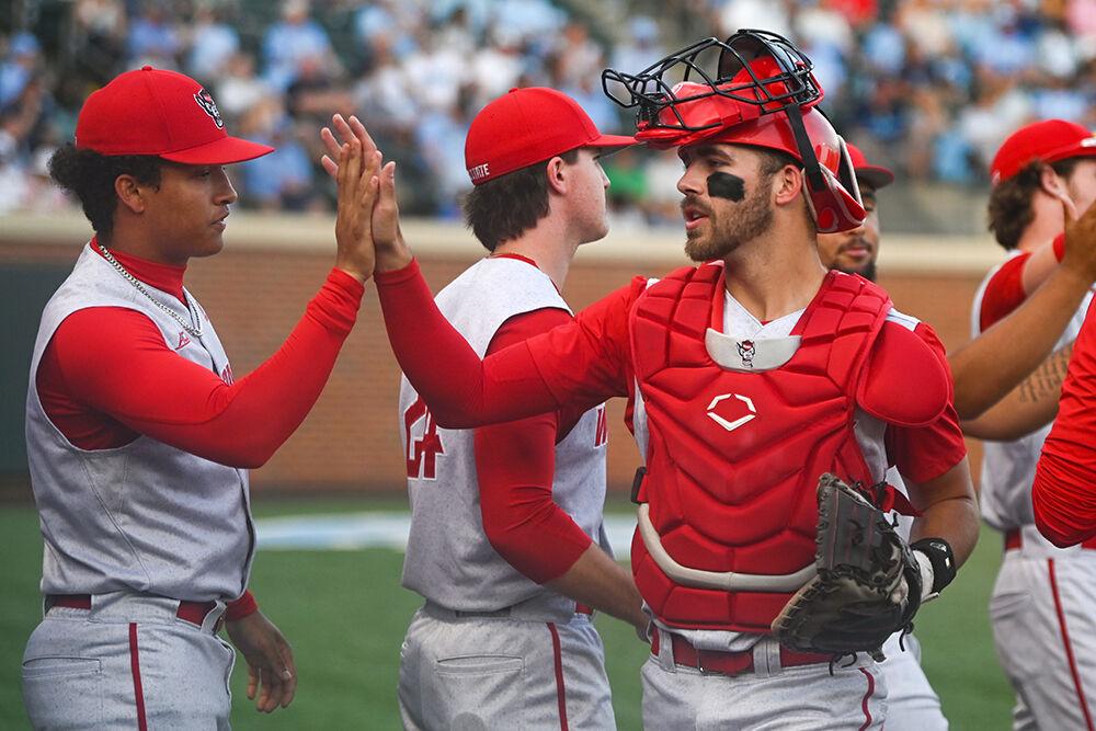Sophomore catcher Jacob Cozart gives his teammate junior pitcher Rio Britton a high-five during the game against UNC-Chapel Hill at Bryson Field at Boshamer Stadium on Thursday, May 11, 2023. NC State lost 9-8.