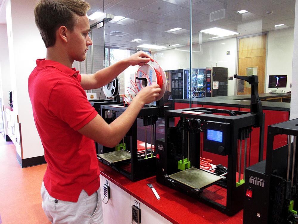 NC State student Aiden Beres works on a project in the makerspace. 3D printers can be found for student use at D.H. Hill Jr. Library.
