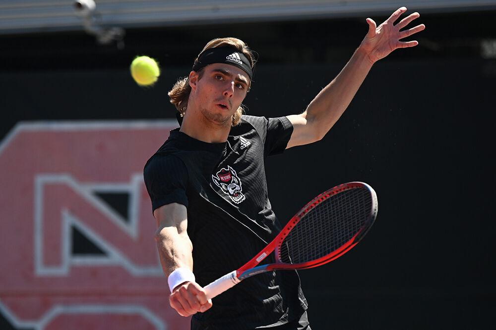 Senior Robin Catry backhands the ball during the match against University of Virginia at the Dail Outdoor Tennis Stadium on Sunday, April 9, 2023. Catry won his singles match 6-4, 6-3. NC State lost 4-2 to Virginia.