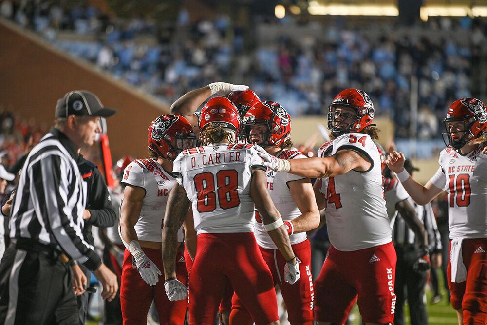 The NC State offense celebrates after a touchdown during the Wolfpack's last regular season football game against the UNC-Chapel Hill Tar Heels at Kenan Memorial Stadium on Friday, Nov. 25, 2022. The Wolfpack beat the Tar Heels in double overtime 30-27.