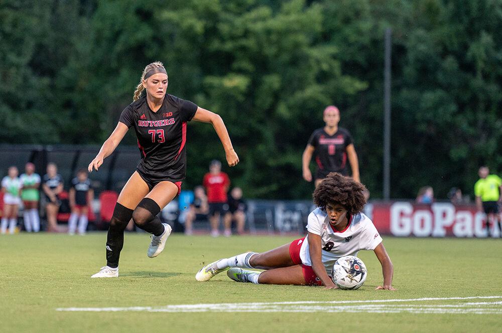 Freshman midfielder Rosalie Olou falls while trying to keep possession of the ball during the match against the Rutgers Scarlet Knights at Dail Soccer Field on Thursday, Aug. 24, 2023. The Wolfpack trailed the Scarlet Knights until a late goal by junior midfielder Annika Wohner tied the game. The Wolfpack tied the Scarlet Knights 1-1.