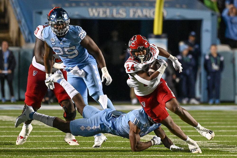 Freshman running back Michael Allen breaks tackles during the Wolfpack's last regular season football game against the UNC-Chapel Hill Tar Heels at Kenan Memorial Stadium on Friday, Nov. 25, 2022. Allen ran for 53 yards as the Wolfpack beat the Tar Heels in double overtime 30-27.