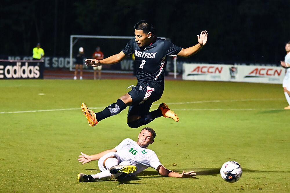 Freshman forward Ervin Cruz jumps over an opponent while fighting for the ball during the match versus USC Upstate at Dail Soccer Field on Monday, Aug. 28, 2023. Cruz scored one goal and made one assist for NC State. NC State beat USC Upstate 3-0.