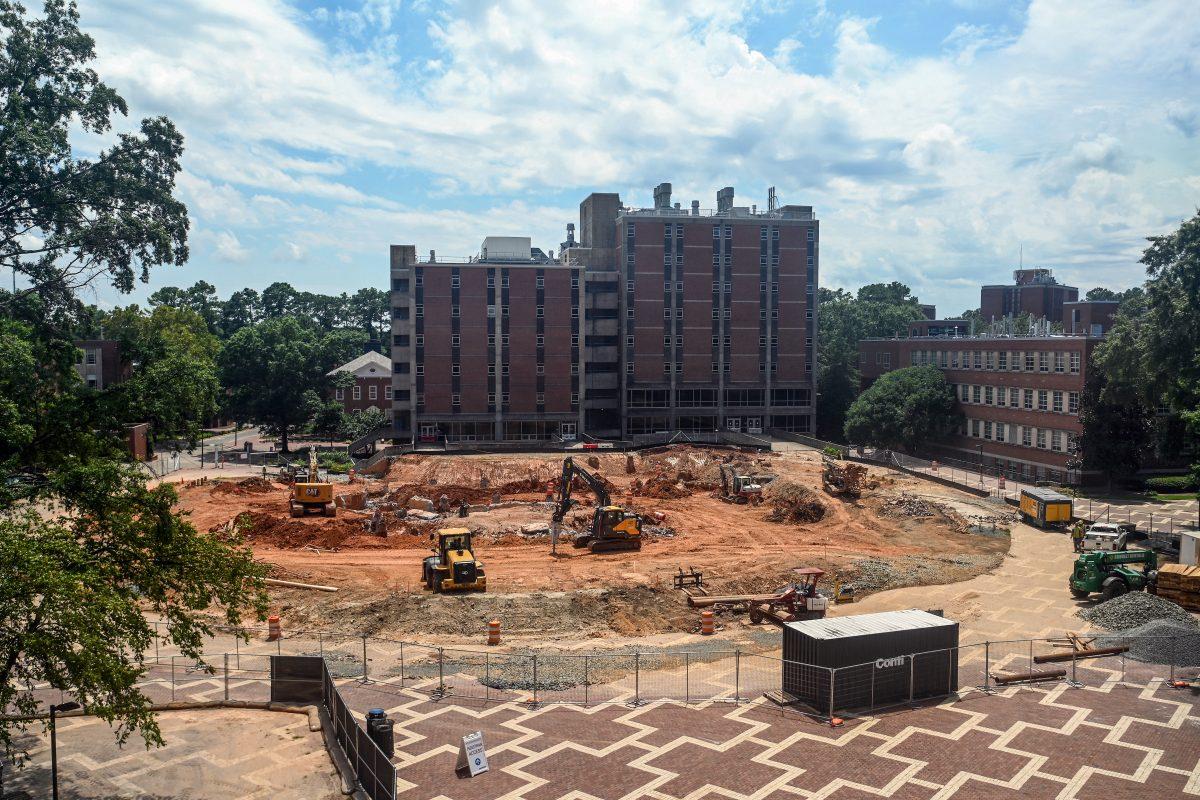 Construction workers prepare the grounds for the new Integrative Sciences Building at the Brickyard on July 31, 2023. The building will replace the temporary greenspace that became a part of the Brickyard after Harrelson Hall was demolished in 2016.