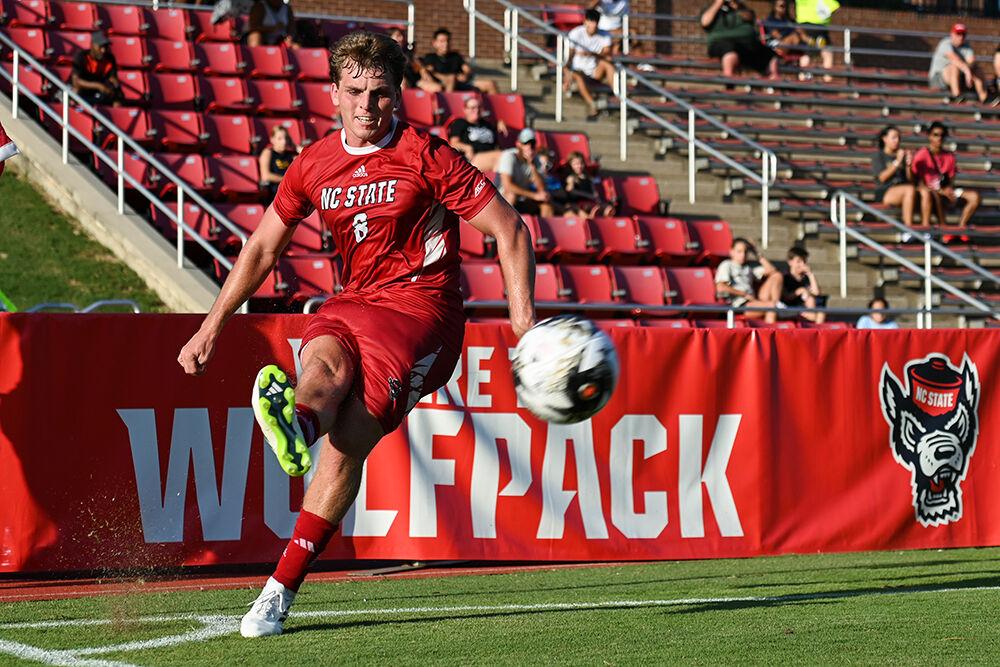 Junior midfielder Will Buete makes a corner kick during the exhibition match against USC at Dail Soccer Field on Sunday, Aug. 13, 2023. NC State beat USC 5-1.