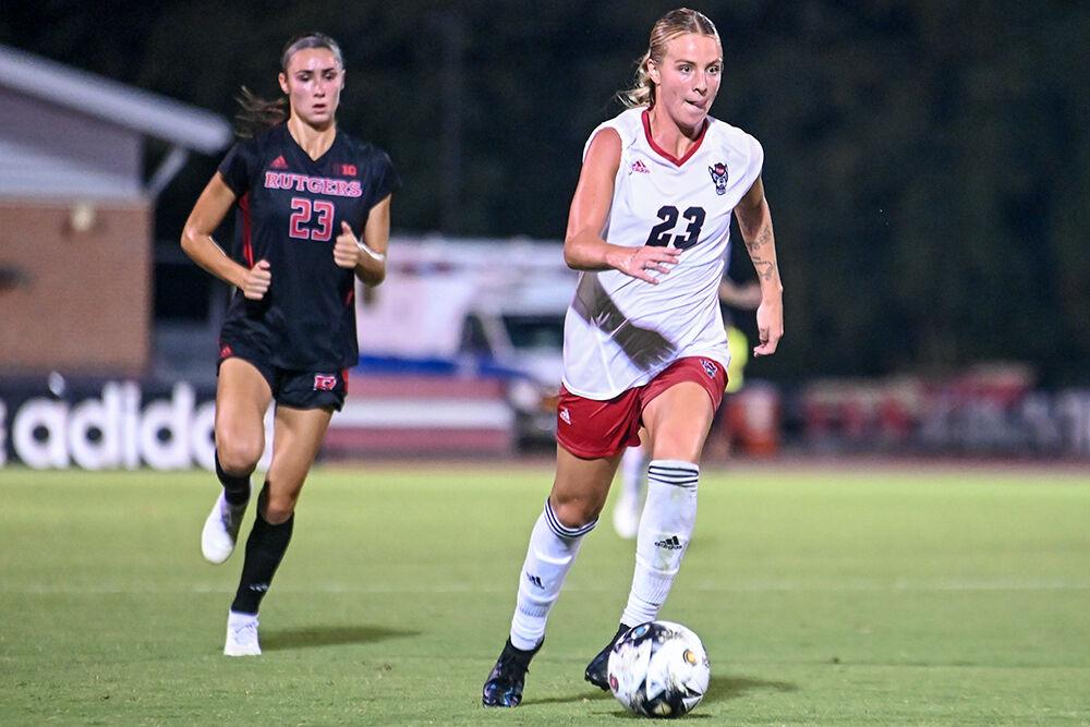 Senior forward Alexis Strickland keeps the ball away from opposing players during the match against Rutgers at Dail Soccer Field on Thursday, Aug. 24, 2023. NC State and Rutgers tied 1-1.