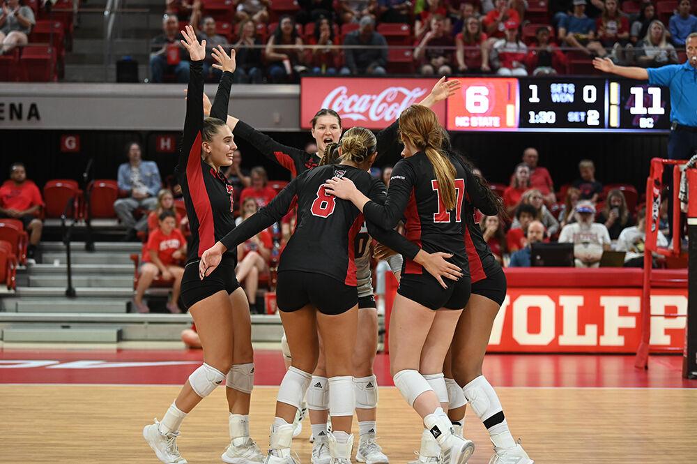 The Wolfpack huddle up in celebration during their home volleyball game against the Boston College Eagles on Sunday, Oct. 16, 2022 at Reynolds Coliseum. The Wolfpack lost to the Eagles 3-2.