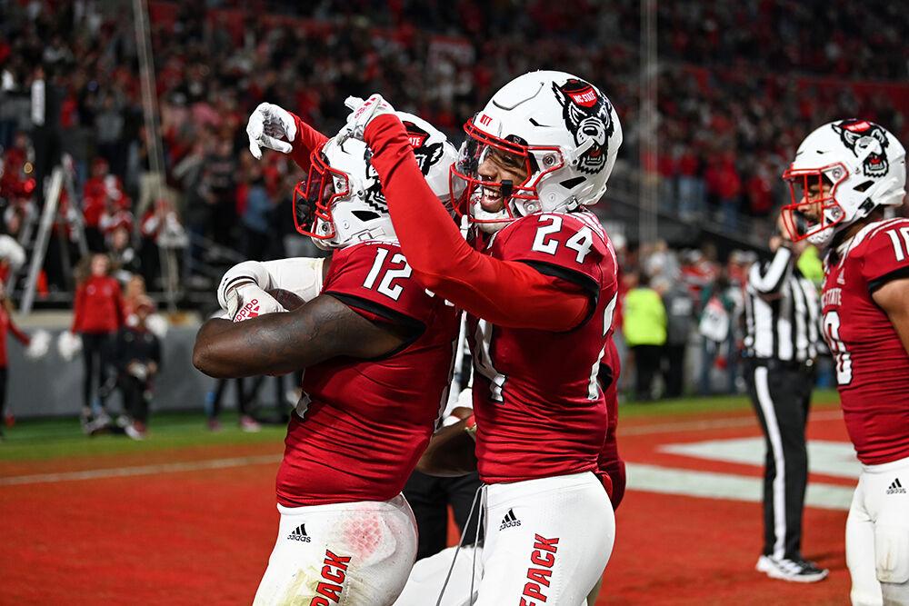 Graduate cornerback Derrek Pitts Jr. (right) celebrates sophomore defensive back Devan Boykin's (left) interception in the game against Florida State University at Carter-Finley Stadium on Saturday, Oct. 8, 2022. The Wolfpack beat the Seminoles 19-17.