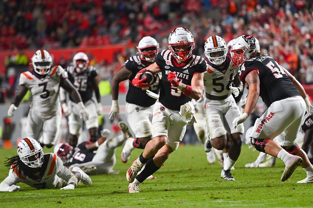 Graduate wide receiver Thayer Thomas runs the ball into the end zone during the Wolfpack's home football game against the Virginia Tech Hokies on Thursday, Oct. 27, 2022 at Carter-Finley Stadium. Thomas had 10 receptions for 118 yards and two touchdowns. The Wolfpack beat the Hokies 22-21.
