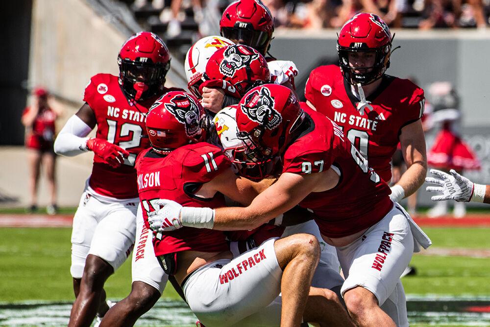 Graduate student linebacker Payton Wilson (left) and graduate student defensive lineman Noah Potter (right) pull down the ball carrier during the game against VMI in Carter-Finey Stadium on Sept. 16, 2023. NC State beat VMI 45-7.