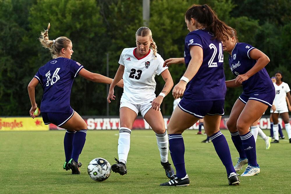 Senior forward Alexis Strickland gets surrounded by opponents during the match against High Point at Dail Soccer Field on Thursday, Sept. 14, 2023. Strickland scored one goal for the Wolfpack. NC State and High Point tied 2-2.