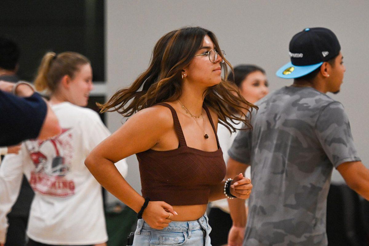 Sophia Jurado, a second-year studying mechanical engineering, spins during the Sube Workshop at Carmichael Gymnasium on Tuesday, Sept. 12, 2023. Sube Ritmo, the only Latin dance team at NC State, taught salsa choreography during their first workshop of the semester.