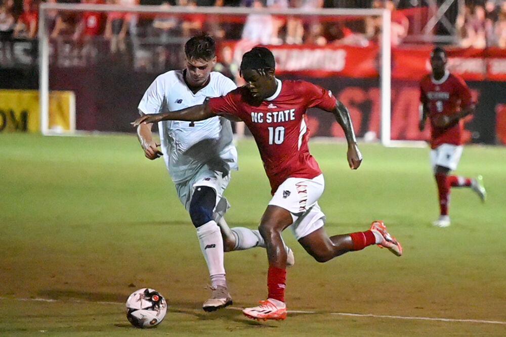 Senior forward Junior Nare attempts to keep the ball in possession during the match against Boston College at Dail Soccer Field on Friday, Sept. 8, 2023. Nare had one shot on goal, three goals attempted and scored one goal for the Wolfpack. NC State won against Boston College 2-0.