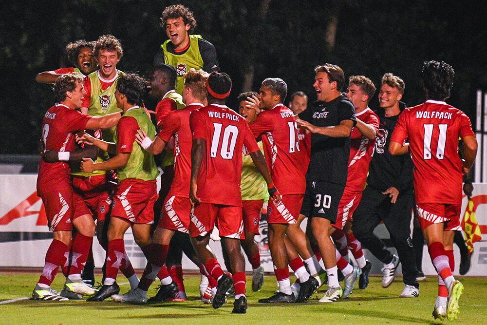 The NC State men's soccer team gathers to celebrate a goal against the University of North Florida at Dail Soccer Field on Wednesday, Sept. 20, 2023. NC State beat the University of North Florida 1-0.
