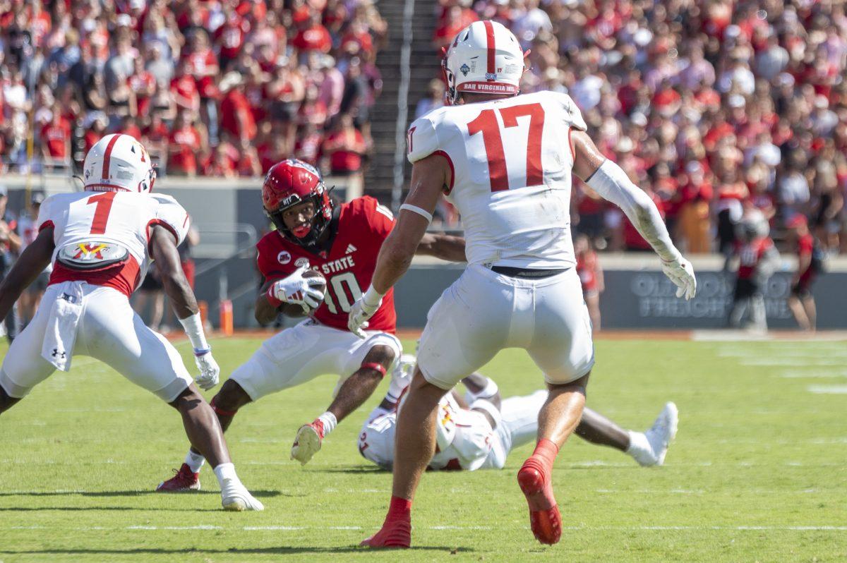 Freshman inside wide receiver KC Concepcion moves away from three opposing players during the football game against Virginia Military Institute in Carter-Finely Stadium on Saturday, Sept. 16, 2023. NC State beat VMI 45-7.