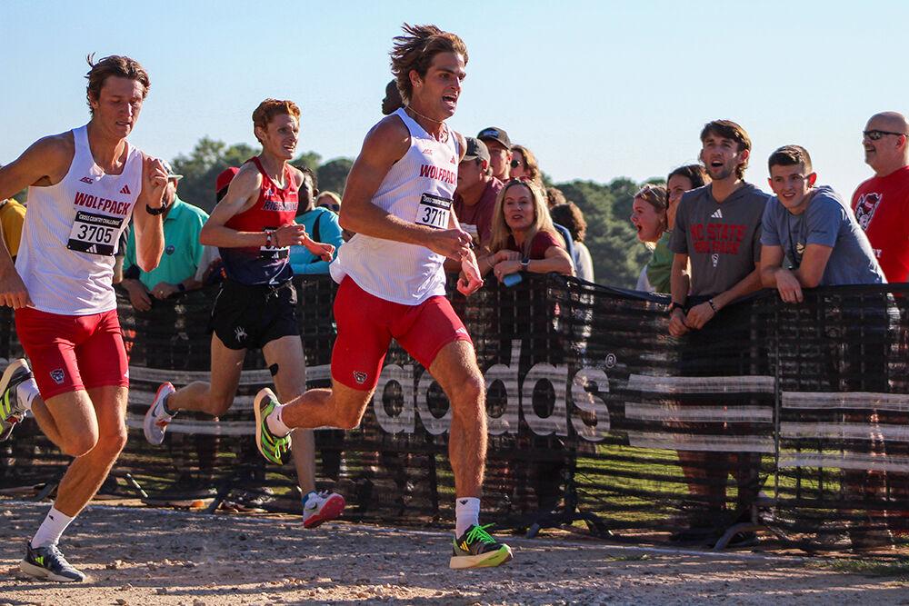 Junior runner Matt Bogdan and senior runner Zach Hughes heading towards the home stretch during the XC Adidas Challenge at WakeMed Soccer Park on Friday, Sept. 15, 2023. Bogdan came in sixth place with a time of 18:10.2 and Hughes came in fifth place with a time of 18:09.5. The men's team won first place overall.