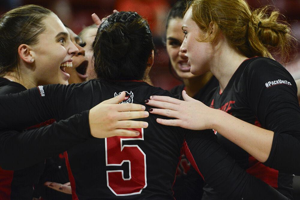 The NC State volleyball team celebrates their victory against Notre Dame at Reynolds Coliseum on Friday, Sept. 29, 2023. NC State beat Notre Dame 3-0.