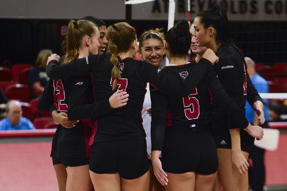 Senior libero Skye Stokes smiles as she celebrates a point victory with her fellow teammates during the volleyball match against Notre Dame at Reynolds Coliseum on Friday, Sept. 29, 2023. NC State beat Notre Dame 3-0.