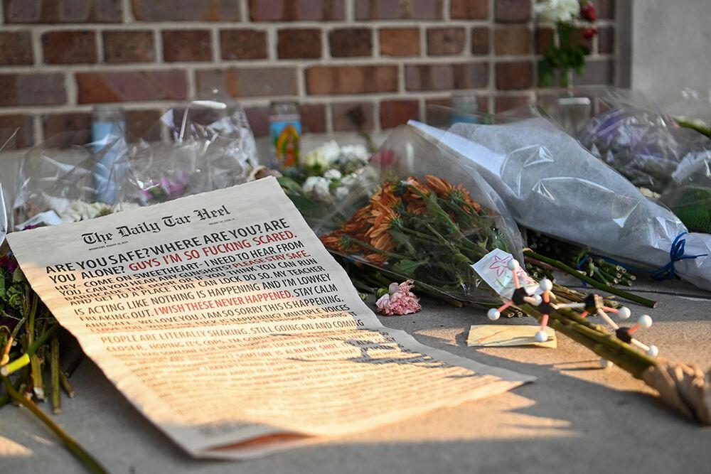 Flowers, candles, letters and a copy of the Daily Tar Heel pile up at a memorial for Zijie Yan at the Morehead-Patterson Bell Tower at UNC-Chapel Hill Sept. 4. Yan, a professor at Chapel Hill, was killed in an on-campus shooting at Caudill Labs Aug 28.
