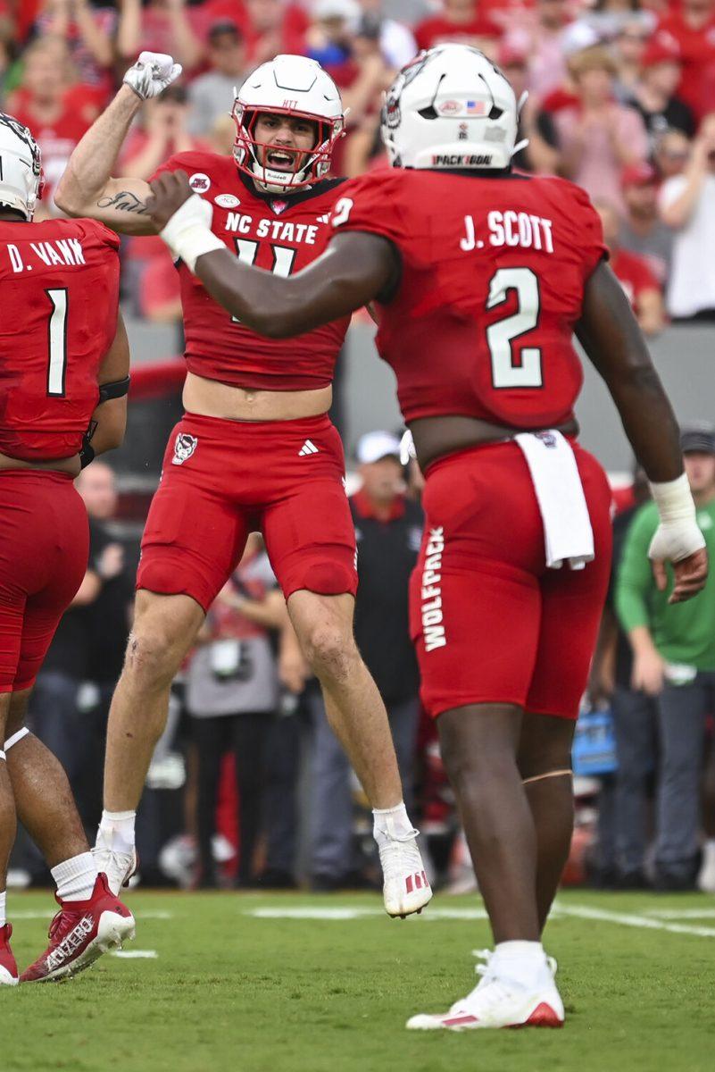 Graduate linebacker Payton Wilson celebrates with his teammate, senior linebacker Jaylon Scott, during the game against Notre Dame at Carter-Finley Stadium on Saturday, Sept. 9, 2023. The Wolfpack fell to the Fighting Irish 45-24.