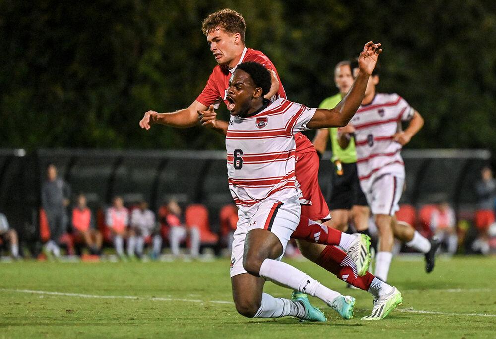 Sophomore midfielder Drew Lovelace takes down a Gardner-Webb player at Dail Soccer Field on Wednesday, Sept. 27, 2023. The Wolfpack beat the Bulldogs 3-1.