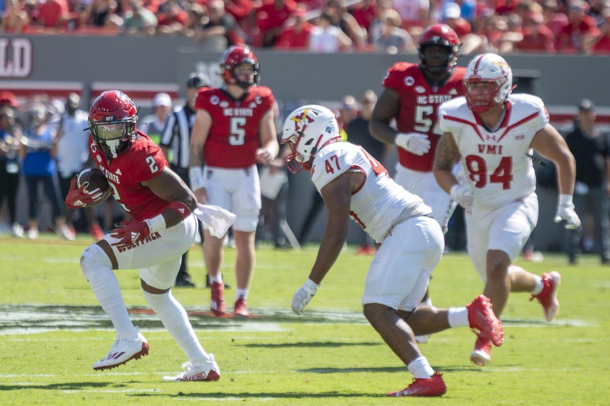 Sophomore running back Michael Allen dodges his opponents during the football game against Virginia Military Institute in Carter-Finely Stadium on Saturday, Sept. 16, 2023. The Wolfpack beat the Keydets 45-7.