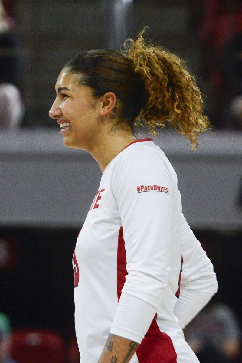 Senior libero Skye Stokes smiles celebrating a point victory during the volleyball match against Notre Dame at Reynolds Coliseum on Friday, Sept. 29, 2023. NC State beat Notre Dame 3-0.