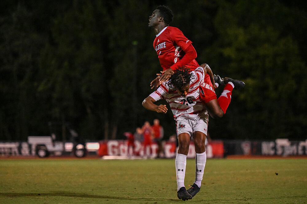 Freshman left center back Lawson Abass jumps over a Gardner-Webb player at Dail Soccer Field on Wednesday, Sept. 27, 2023. Abass scored one goal against Gardner-Webb. The Wolfpack beat the Bulldogs 3-1.