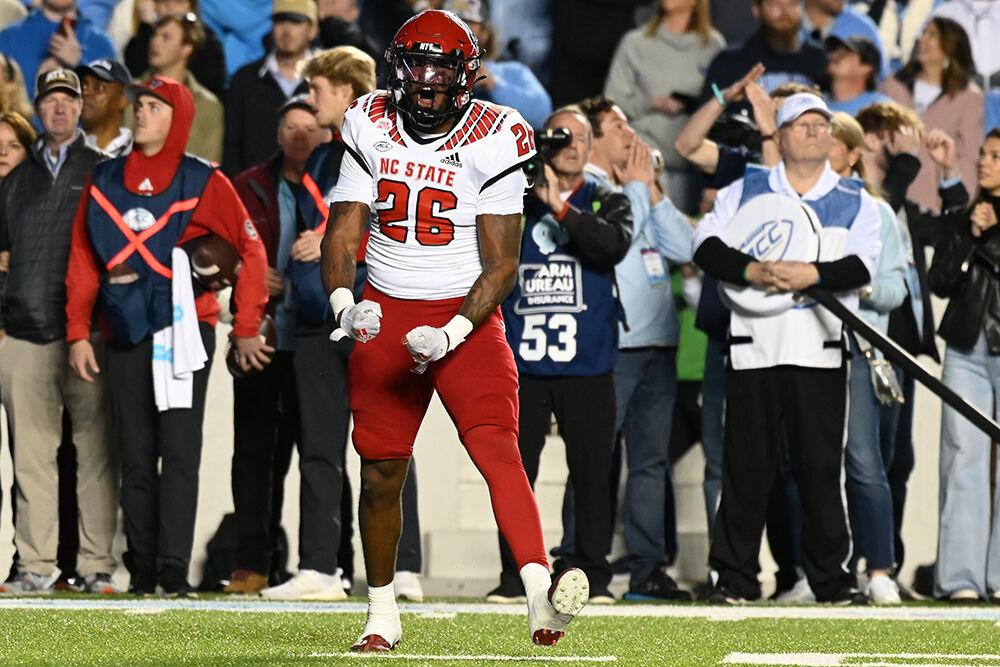 Sophomore linebacker Devon Betty celebrates a defensive stop during the Wolfpack's last regular season football game against the UNC-Chapel Hill Tar Heels at Kenan Memorial Stadium on Friday, Nov. 25, 2022. The Wolfpack beat the Tar Heels in double overtime 30-27.