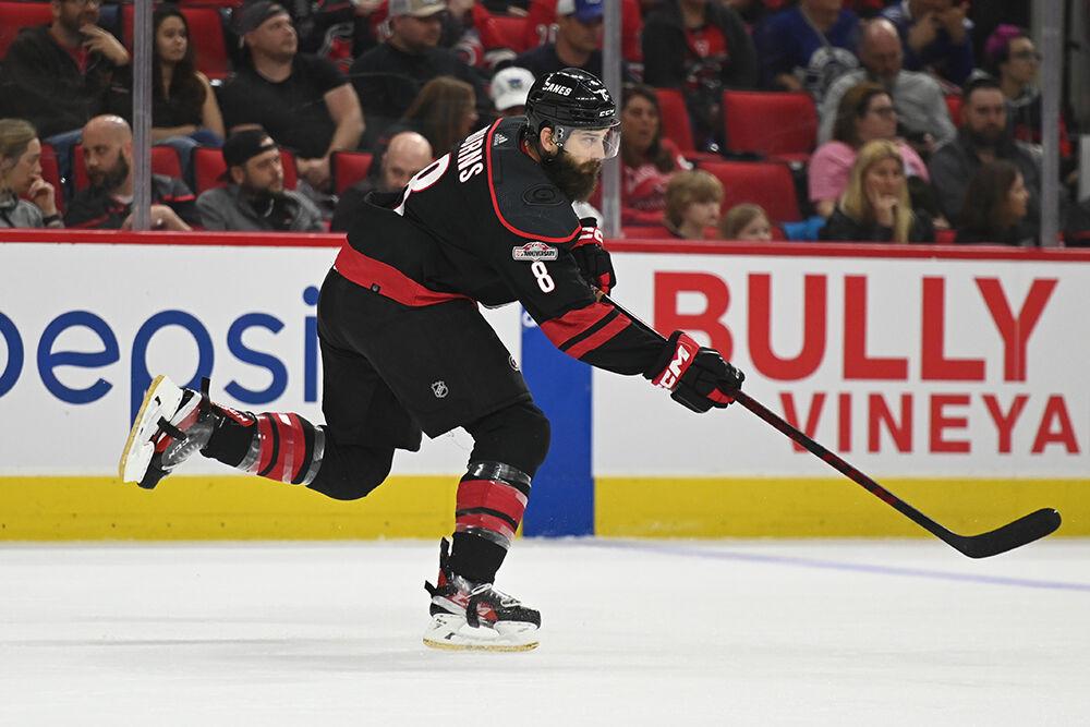 Carolina centreman Brent Burns slaps the puck up the ice during the Hurricanes' home game against the Tampa Bay Lightning in PNC Arena on Tuesday, March 28, 2023. The Lightning beat the Canes 4-0.