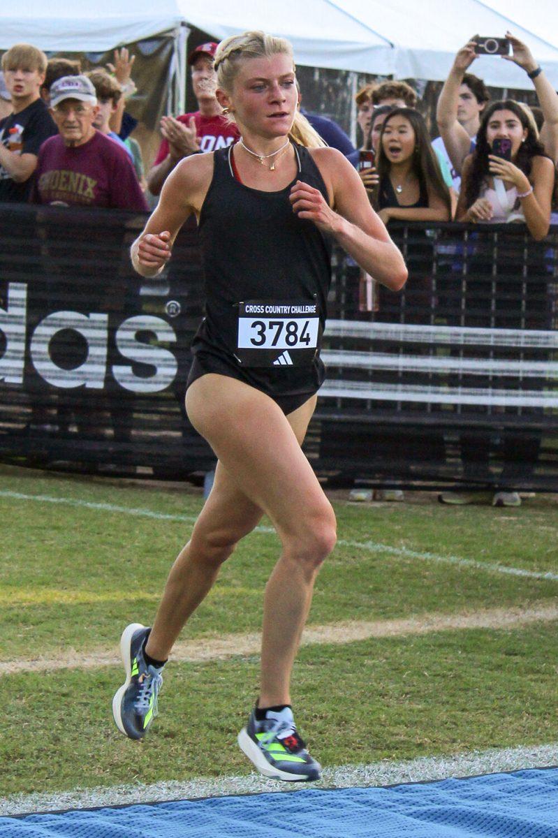 Freshmen Leah Stephens crosses the finish line during the XC Adidas Challenge at WakeMed Soccer Park on Friday, Sept. 15, 2023. Stephens took first place with a time of 16:54.8.