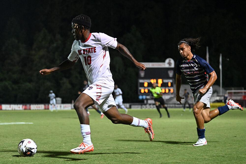 Senior forward Junior Nare dribbles the ball down the field during the match against Howard at Dail Soccer Field on Tuesday, Sept. 12, 2023. Nare scored one goal and made one assist. NC State beat Howard 3-1.