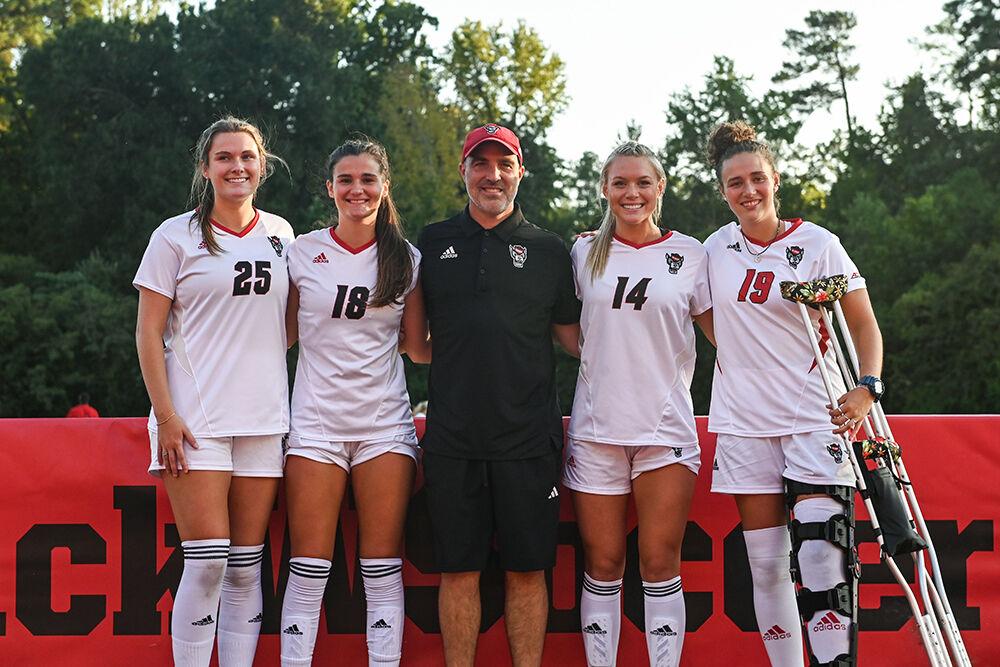 Junior midfielder Sarah Arnold, senior defender Madison Reid, head coach Tim Santoro, senior forward Mia Vaughan and senior goalkeeper Maria Echezarreta pose for a photo during the senior night celebrations at the match against High Point at Dail Soccer Field on Thursday, Sept. 14, 2023. NC State and High Point tied 2-2.